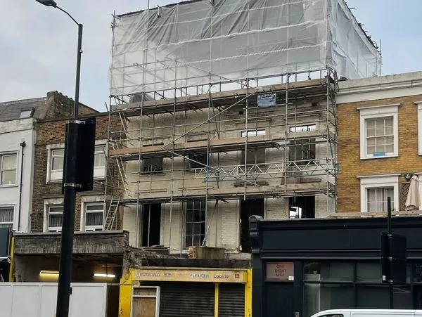 Commercial building scaffolded for full facade refurbishment, London